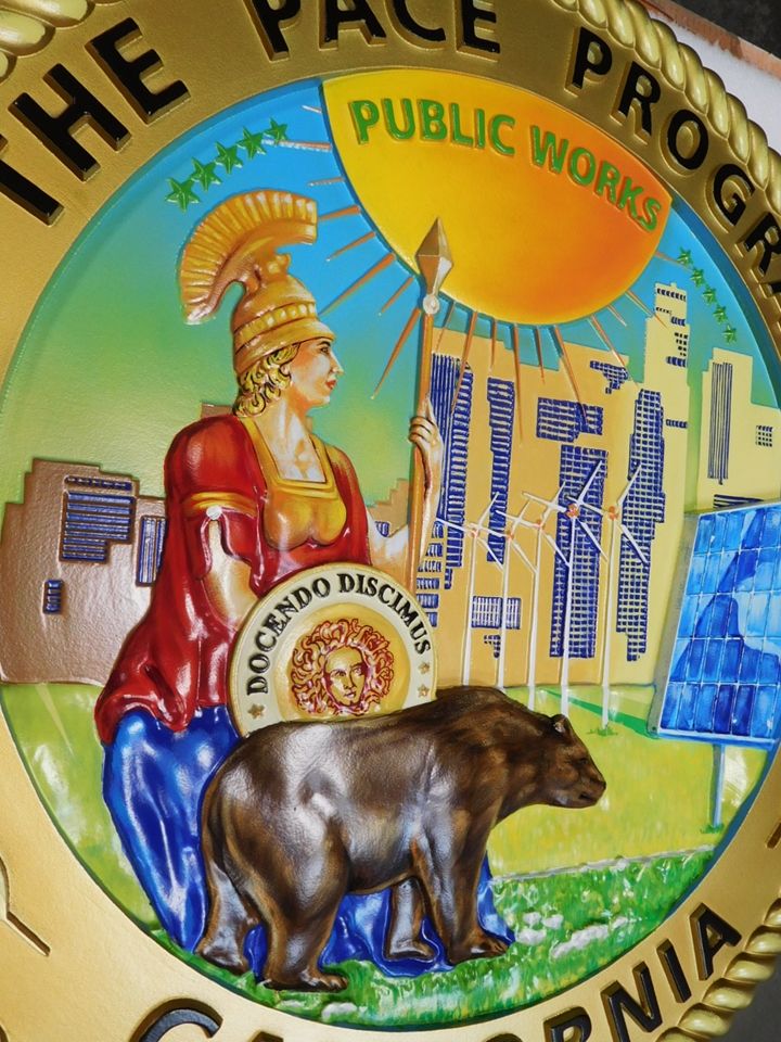 BP-1033- Close-Up Photo of Carved Plaque of the Seal of the PACE Program, 3-D Artist-Painted