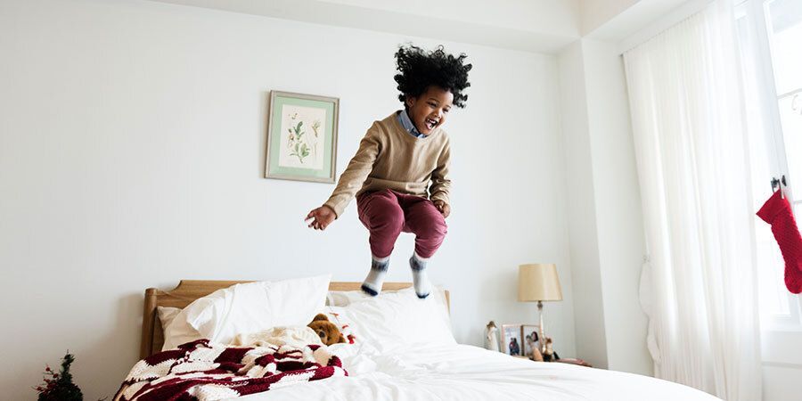 Kid jumping on bed