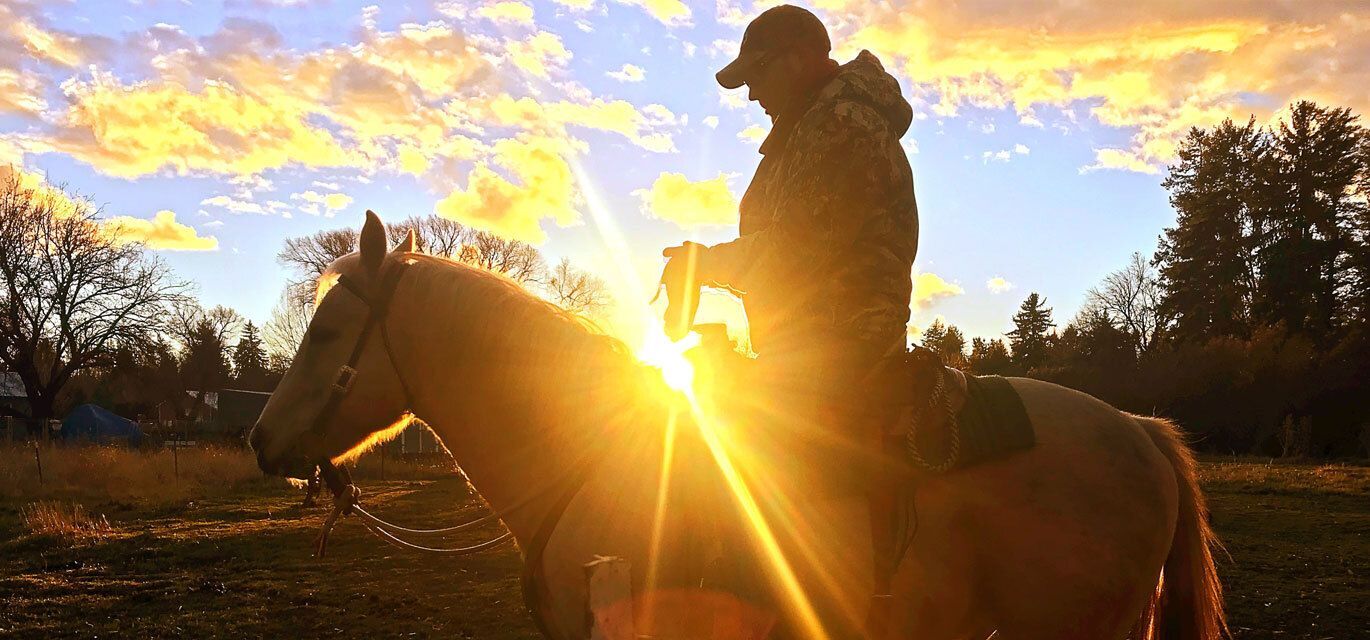 Man on a horse during sunset