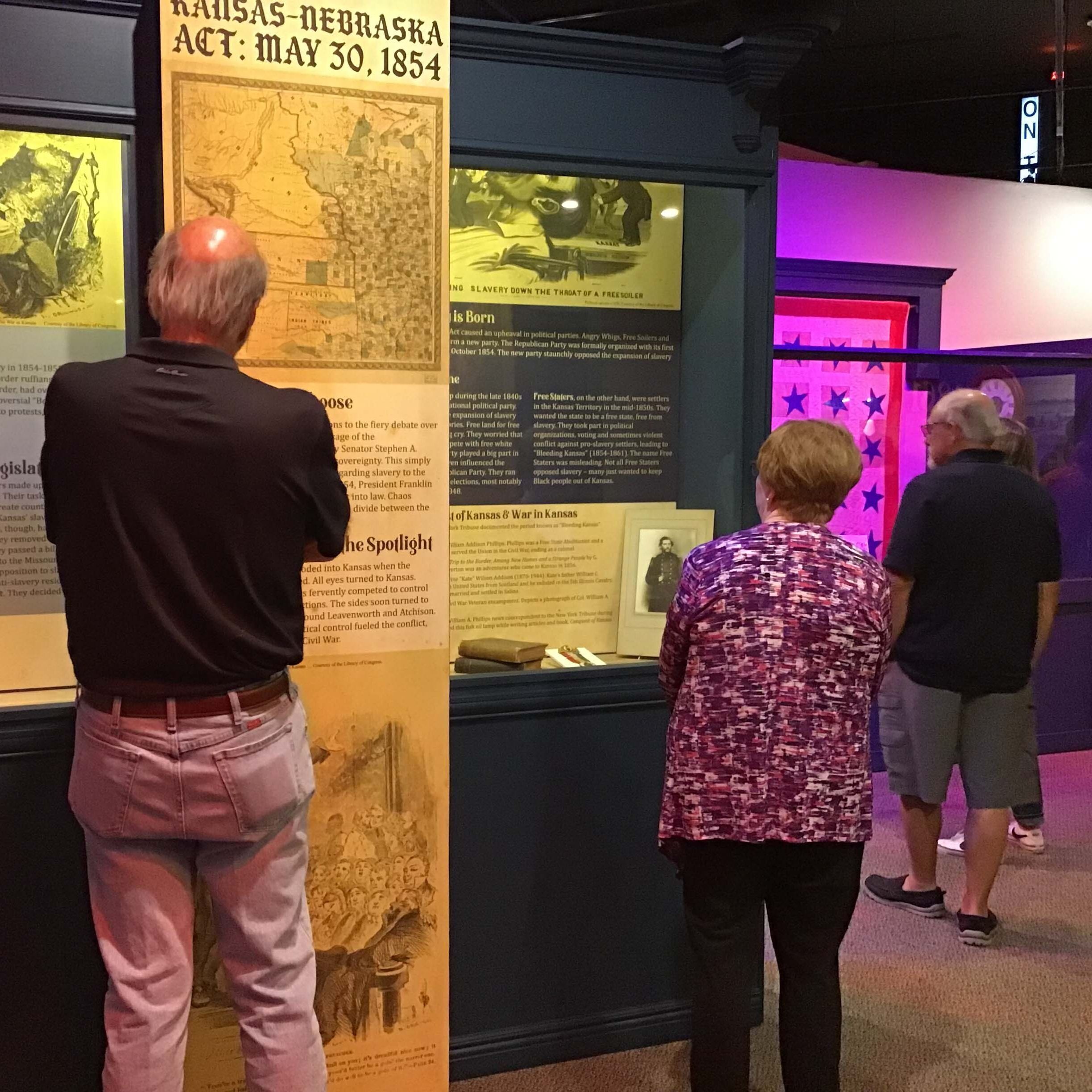 Exhibit with pre Civil War theme, featuring people reading display boards.