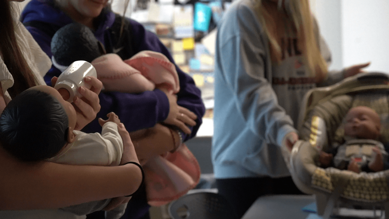 Students holding RealCare Simulation babies. 