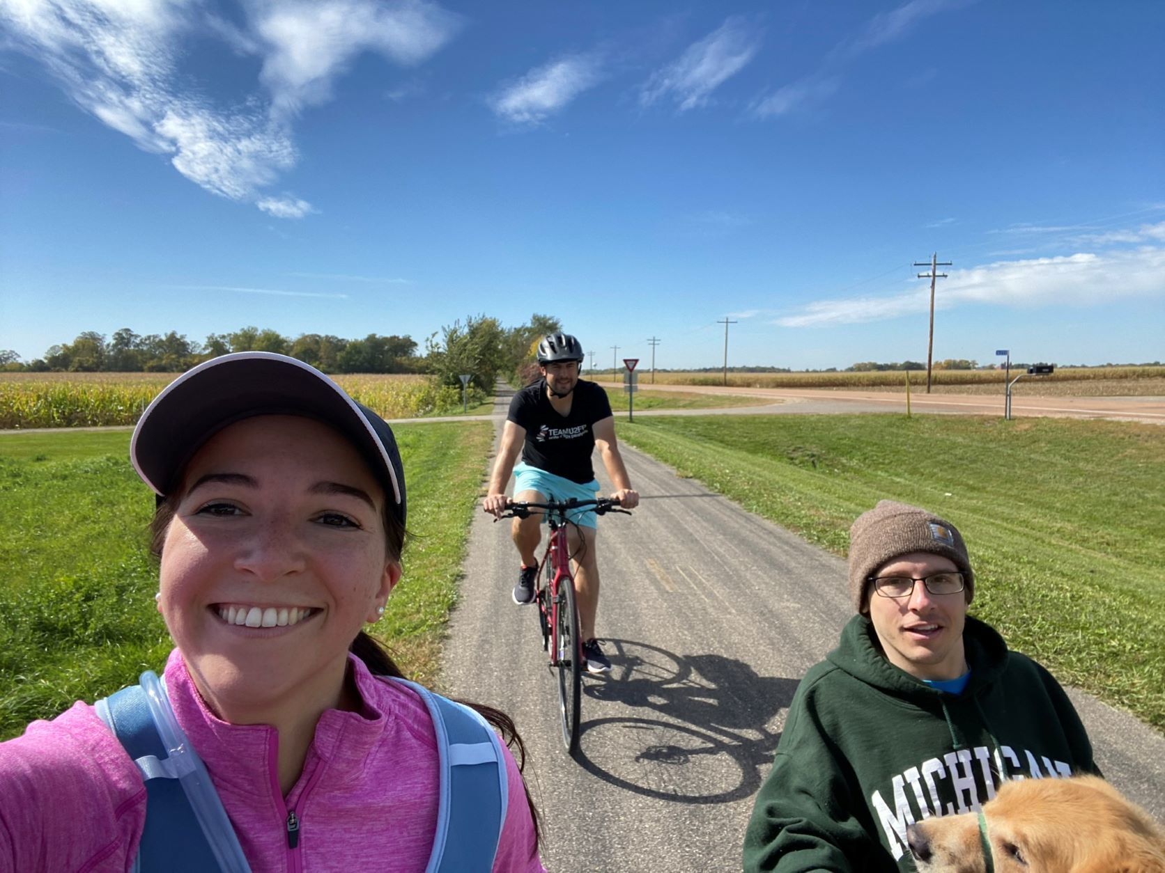 Laura Valderrama Figueroa, Gus Beckstrom, Jake Beckstrom, and Foster (Jake's service dog) on a concrete path during last year's Freestyle Challenge