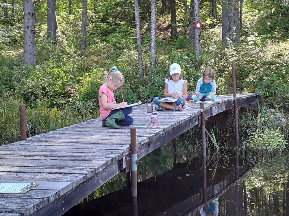 nature journaling on a bridge