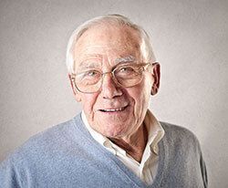 Elderly man smiling.