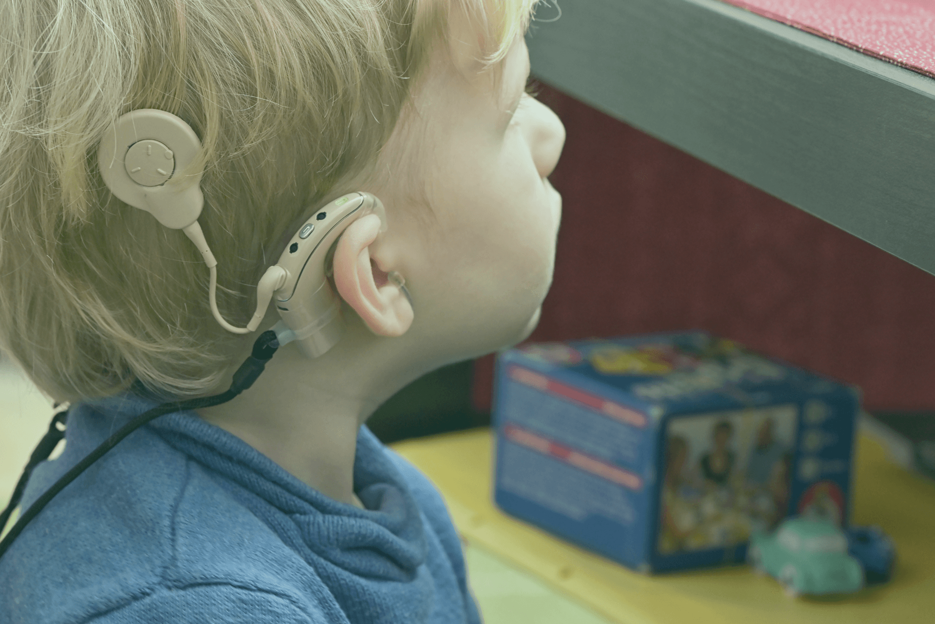 child with cochlear implant looking off in the distance