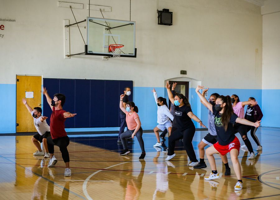 Raul teaches dance moves to participating youth.