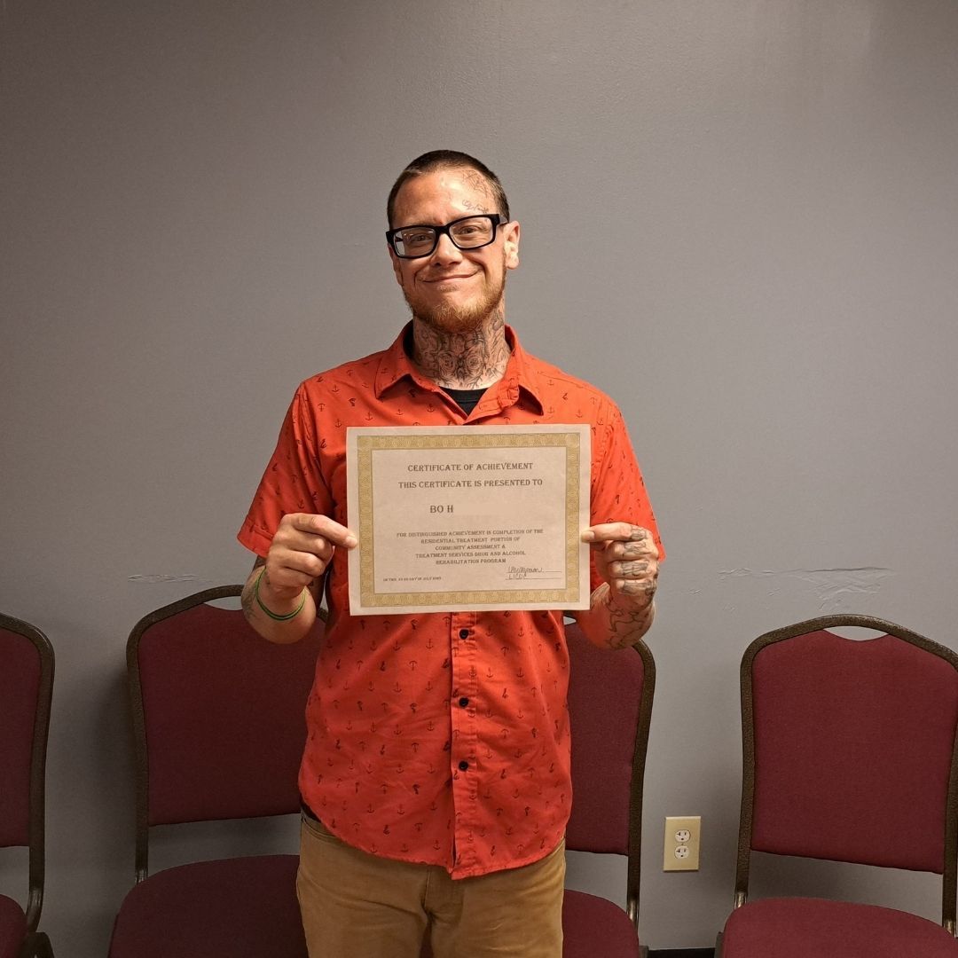 Photo of Bo with his CATS graduation certificate