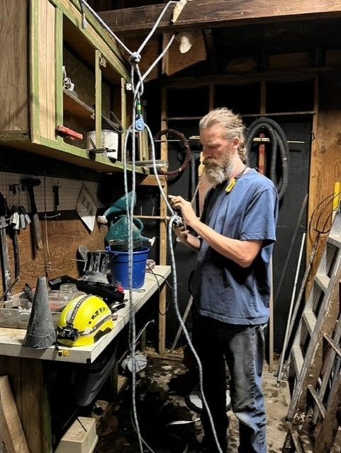 Rescuer Gandalf creates a pulley system to help leverage the javelinas out of the basement