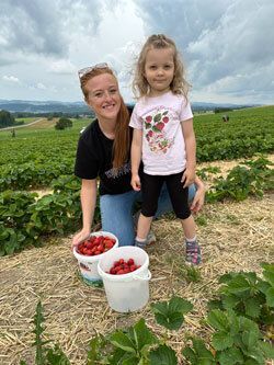 Elisabeth Dalke and her sister picking strawberries