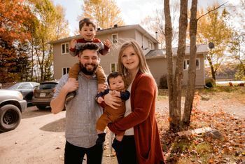 family in front yard of house