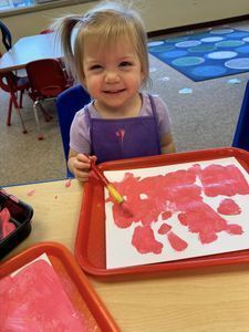 Toddler playing with playdough.