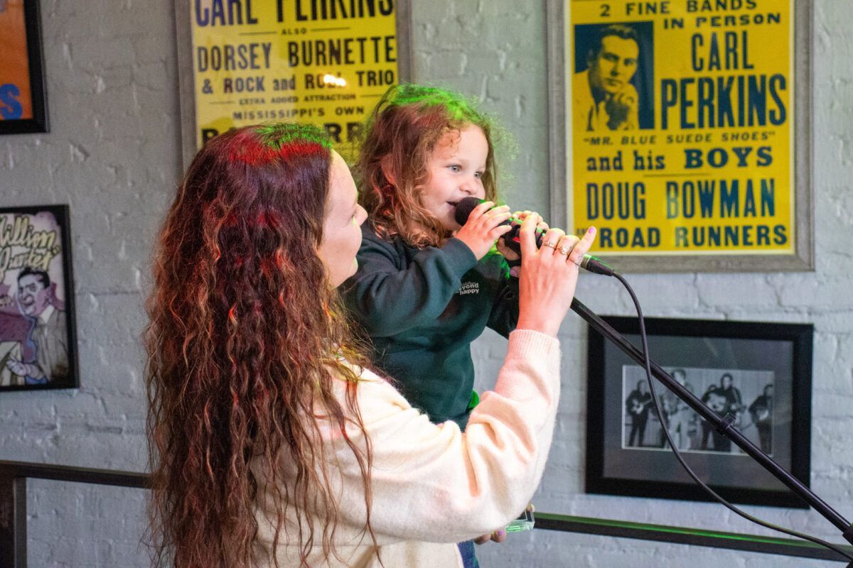 Child singing into a microphone