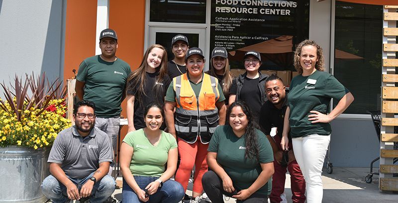 Photo of smiling staff standing in front of the Food Connections Resource Center