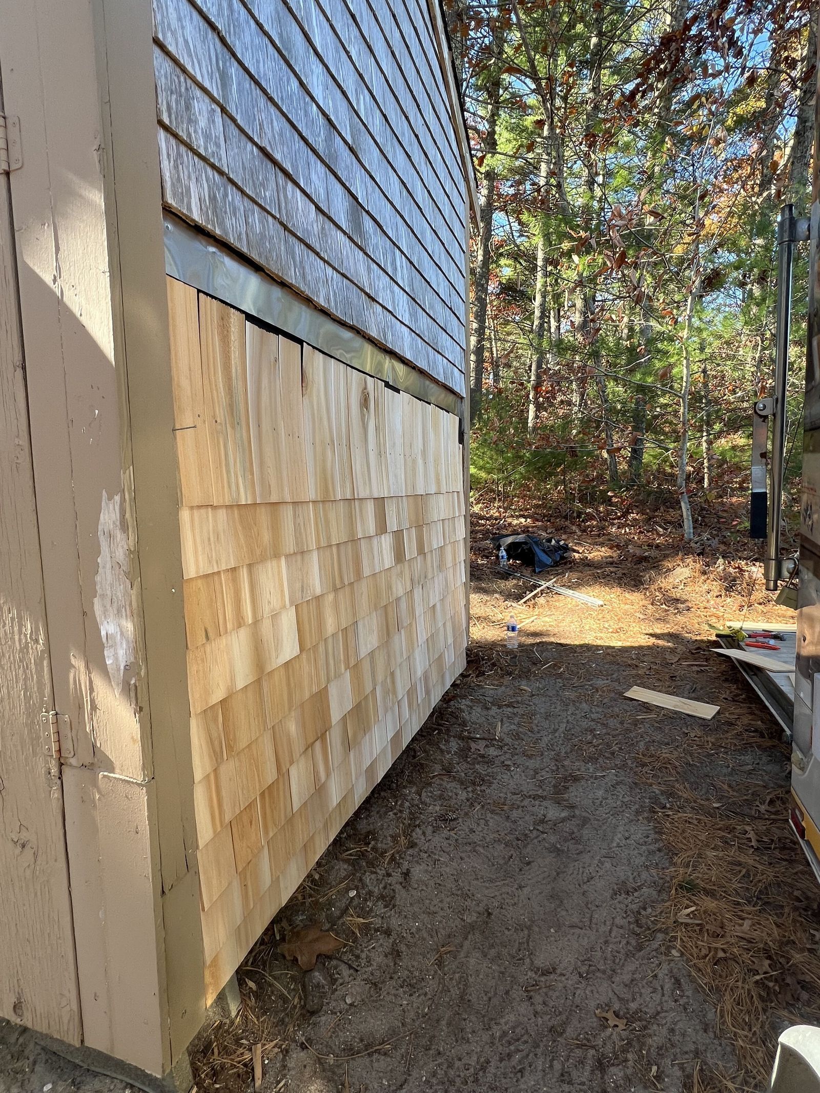 Side of shed with new cedar shingles