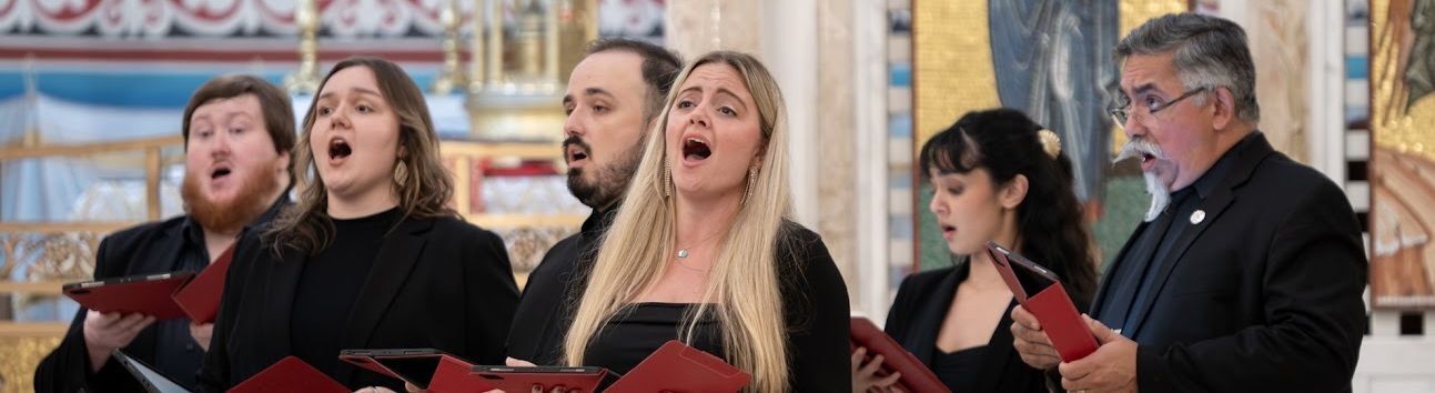 Seraphic Fire artists and conductors in front of a decorative pink background.