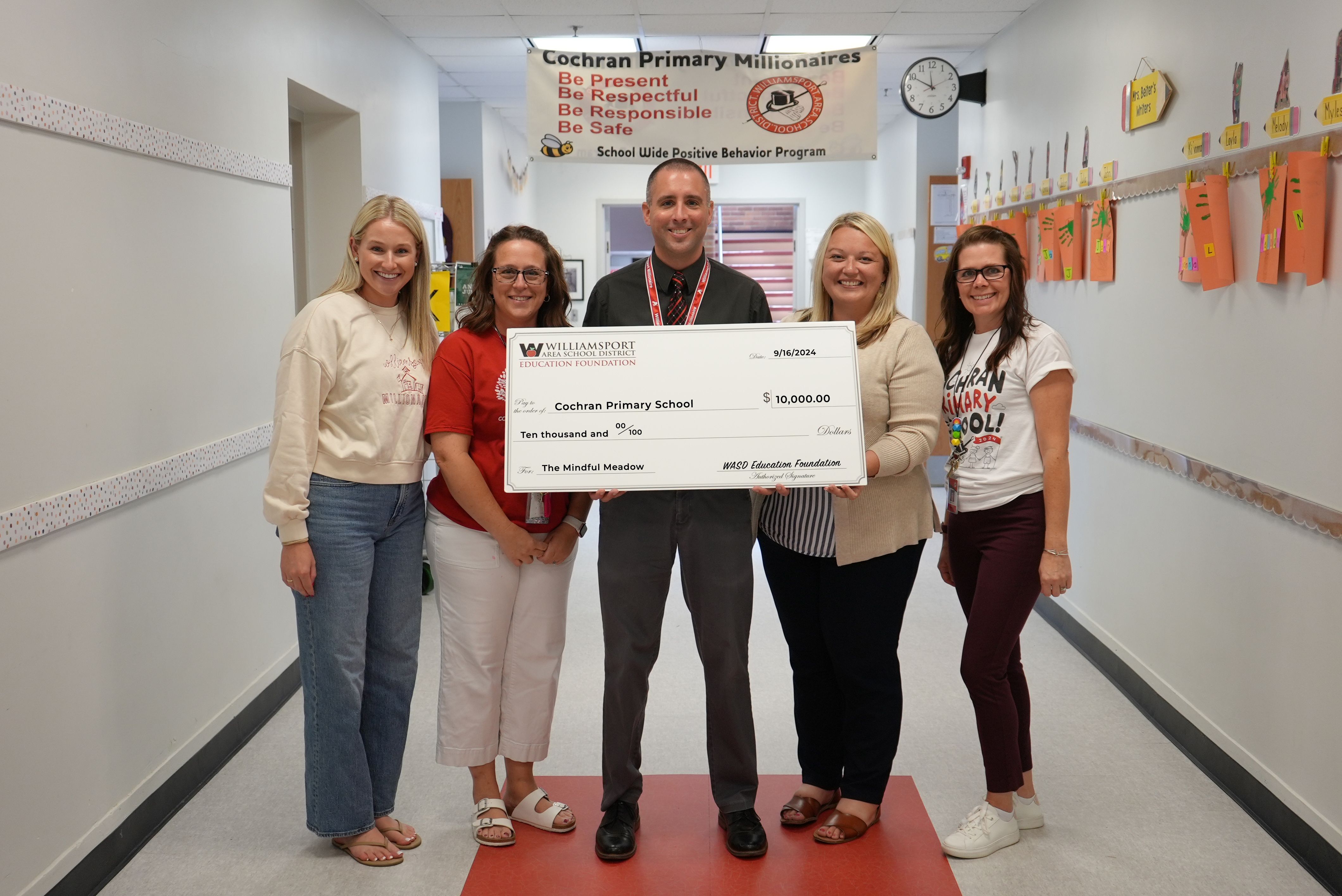 WASDEF officials present a $10,000 check to Cochran Primary School teachers.