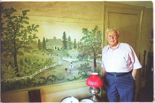 Mays with a mural in his home