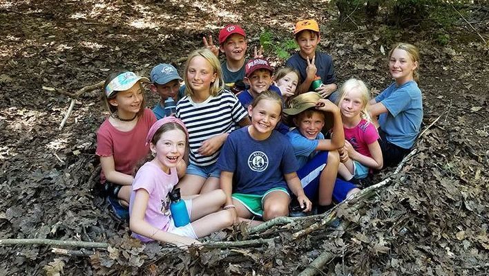 children in a larger-than-life bird nest