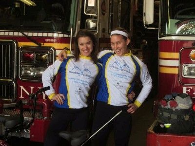 Rebecca and Caroline posing and smiling in front of firetrucks