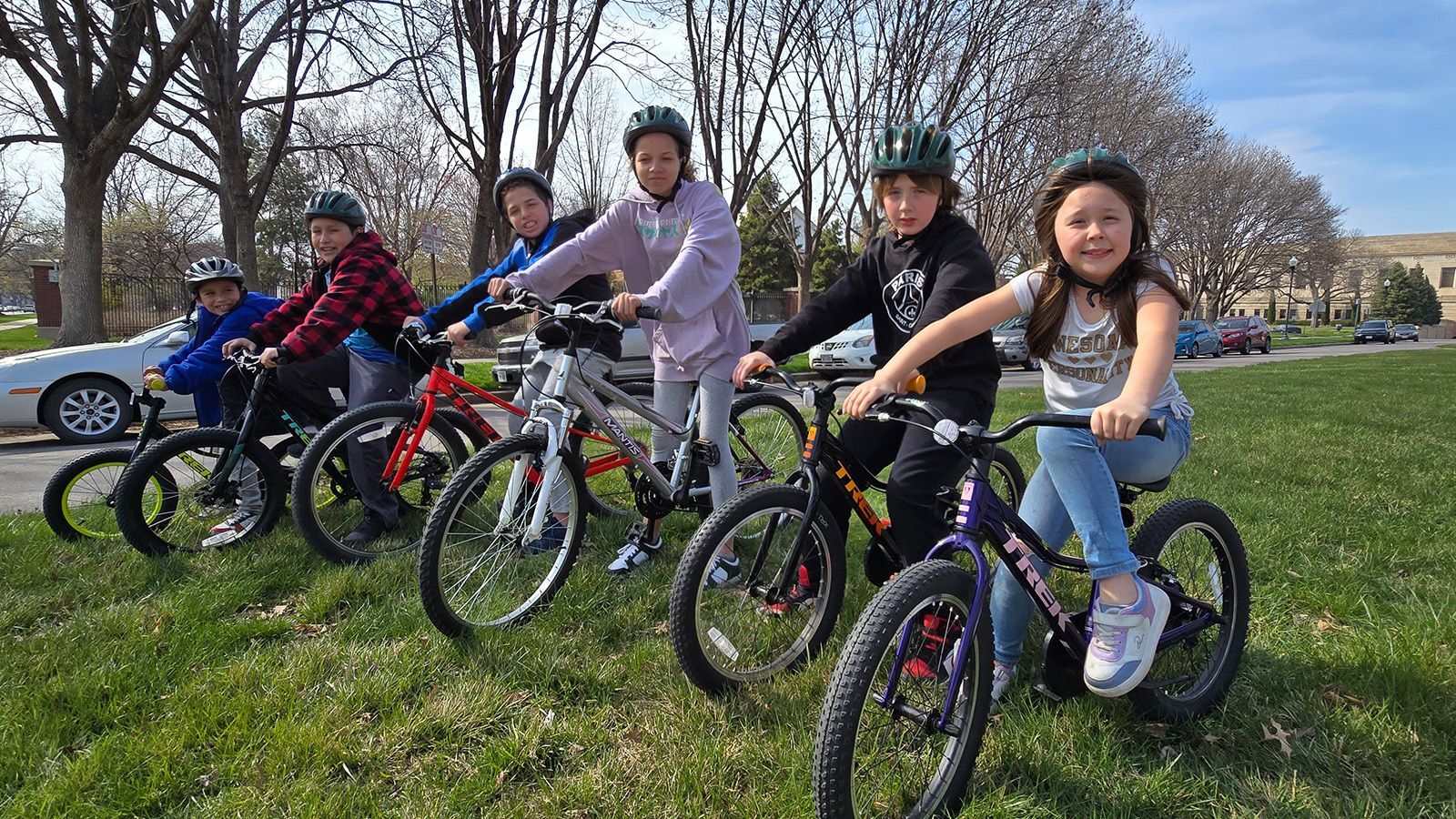 Children at McPhee Elementary ride their new bikes from LBK.