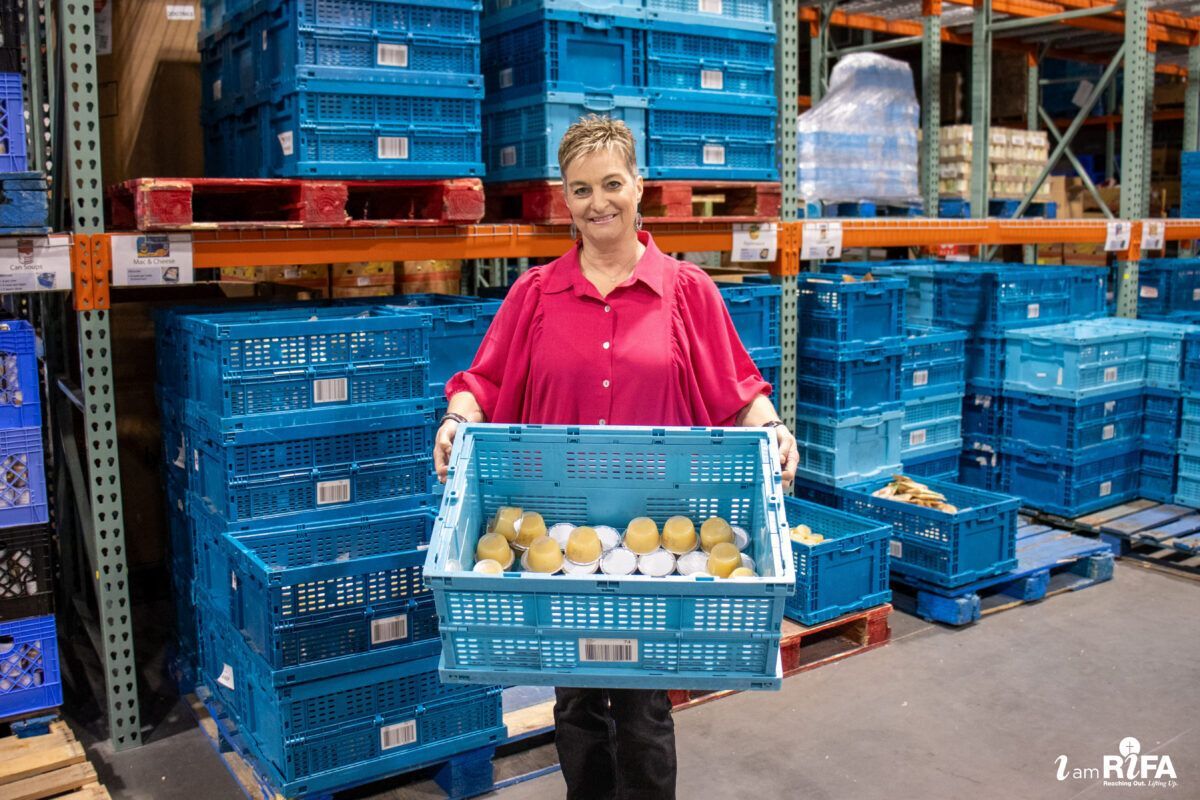 Cassandra Fuller holding a box of applesauce