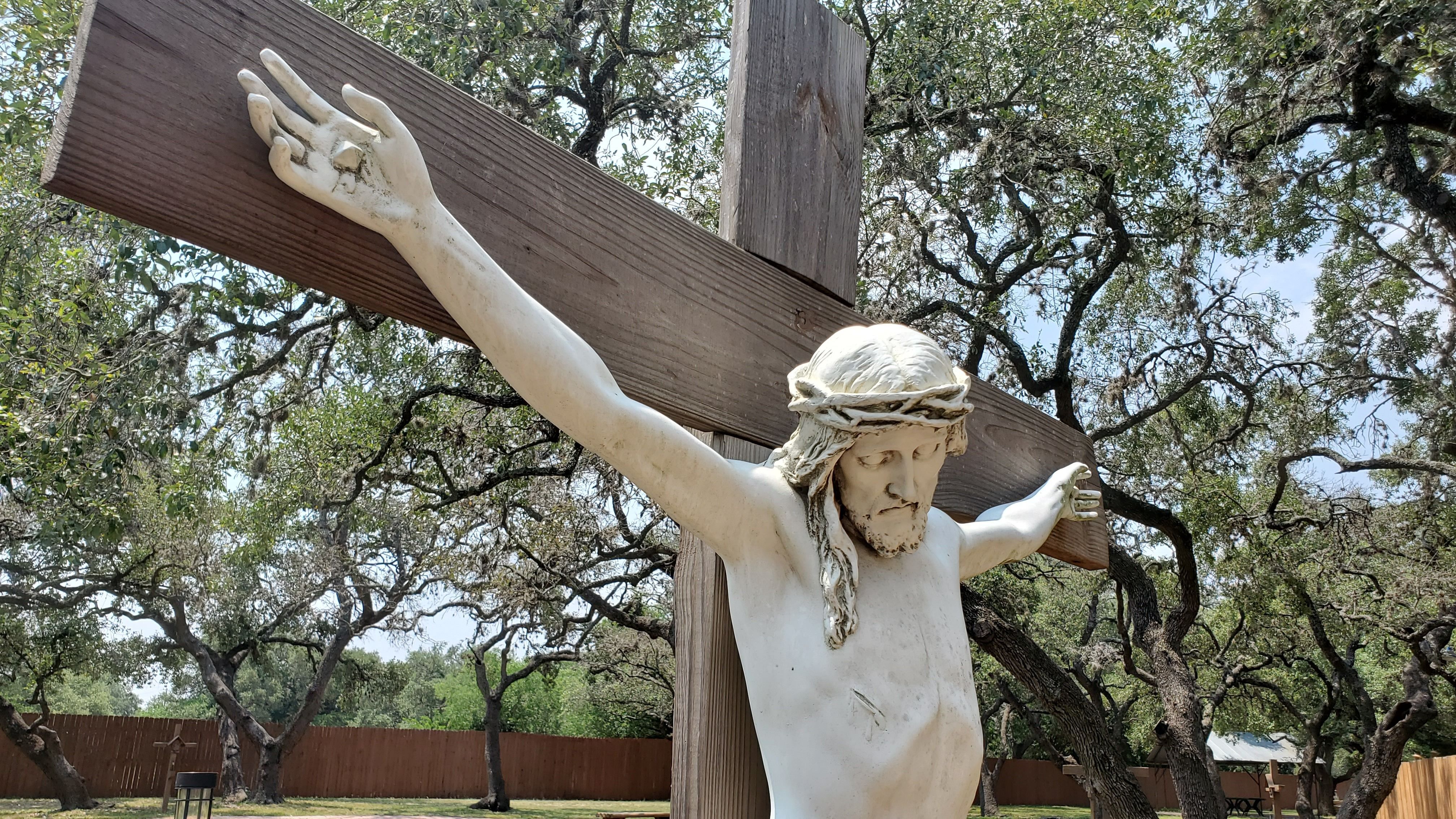 Crucifix with trees in background