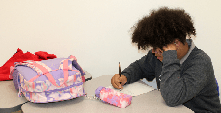 A child in the Home for Families afterschool program works on homework. 