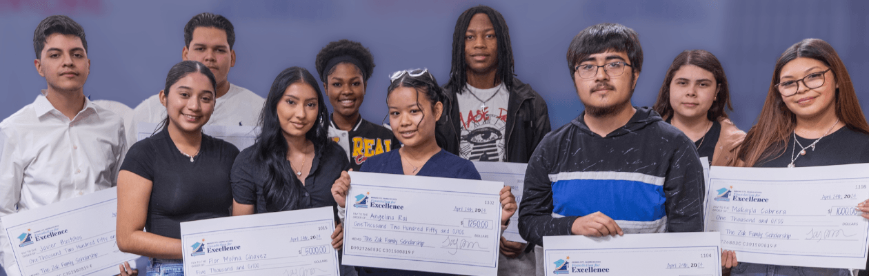 Students holding scholarship checks