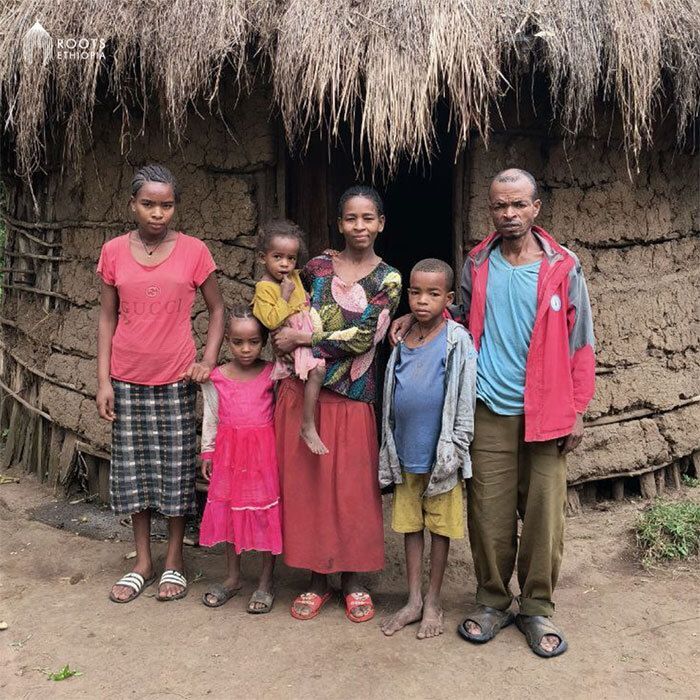 Demekech and her family in front of their home