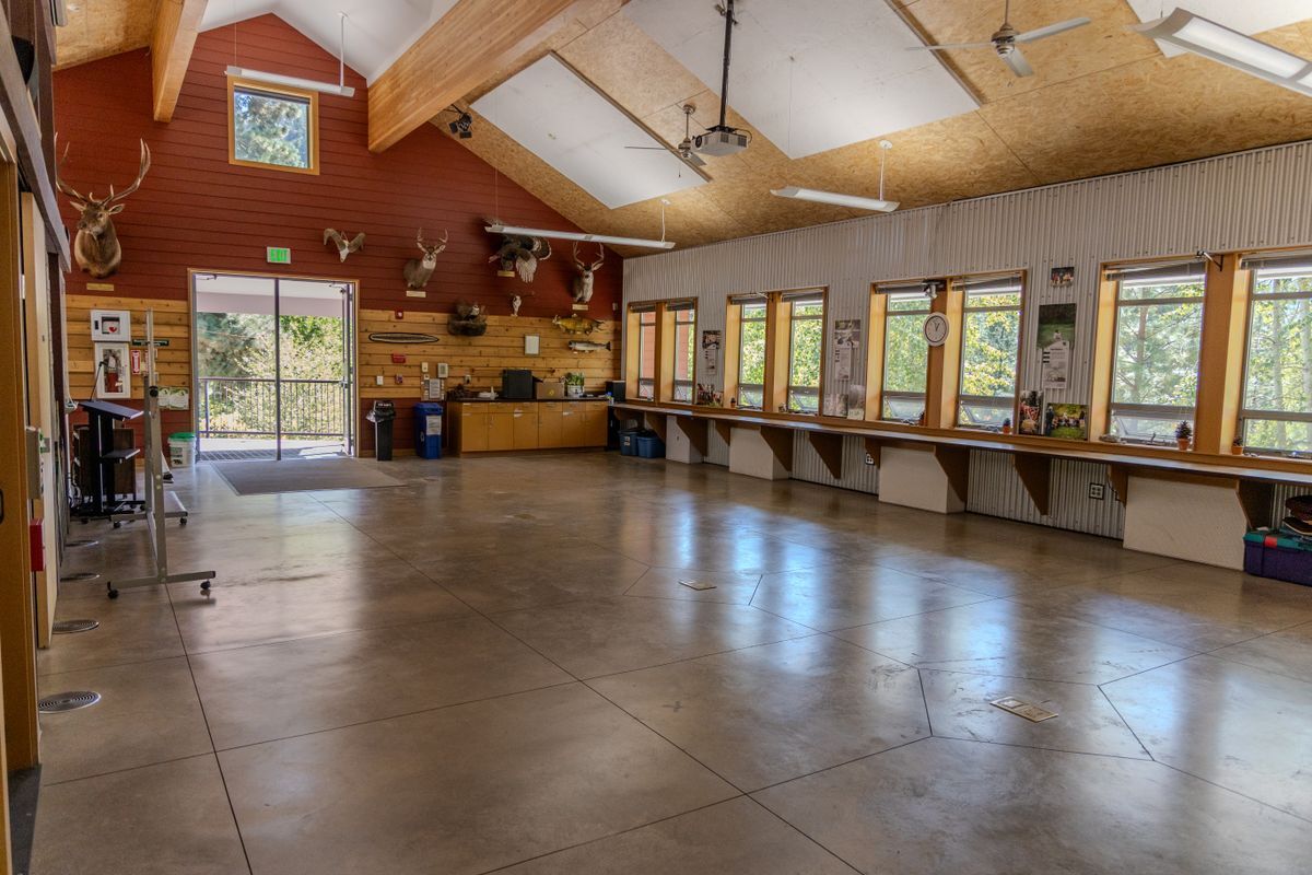 An image taken inside the Red Barn facing the double door entryway with a wide open event space.