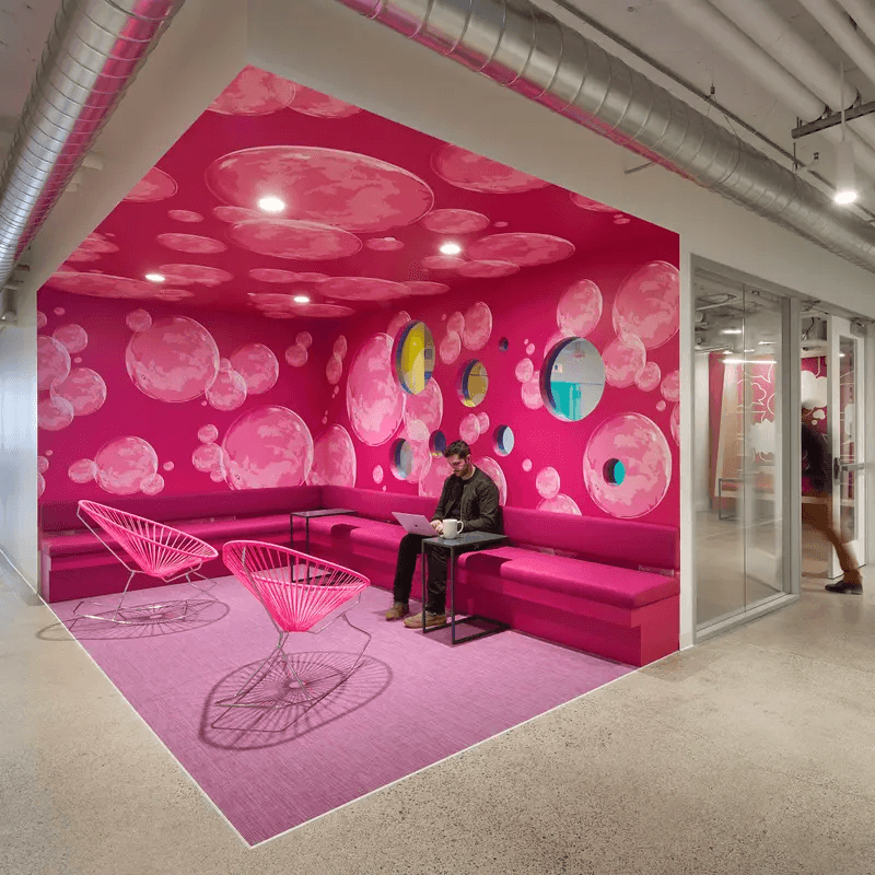 shades of pink wall paper with a man sitting on a bench