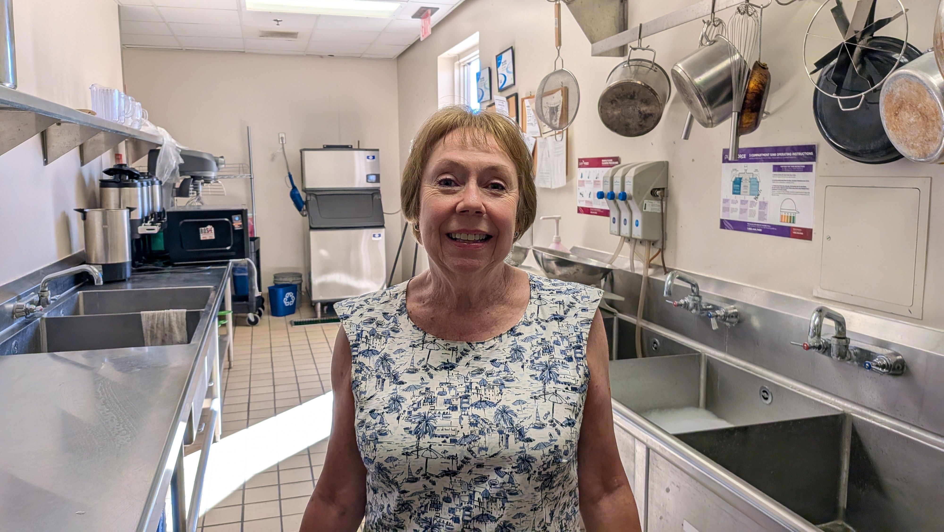 A woman smiling standing in a kitchen
