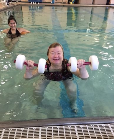 Two people in the pool for aquatic exercising.