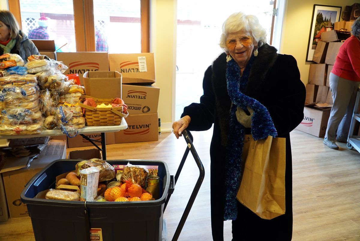 Senior woman with a bin full of fresh food