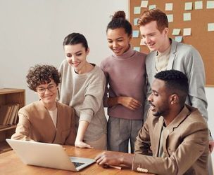 Five people gathered around a laptop