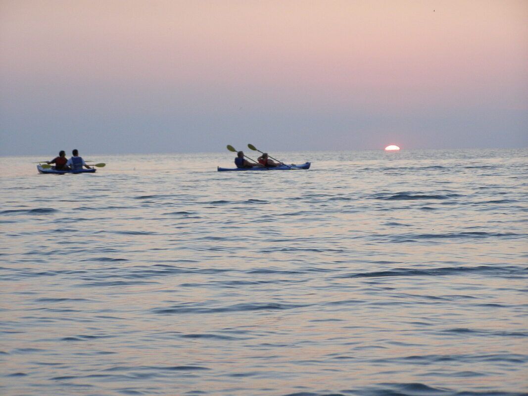 Kayakers on the lake at sunset.