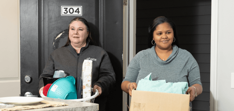 A case manager at Home for Families meets with a client who was dealing with homelessness and helps them move into a new apartment