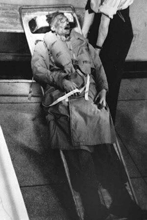 A black and white photo of a corpse dressed in a military uniform.