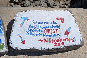 Painted brick with Bible verse about Christ as the only foundation