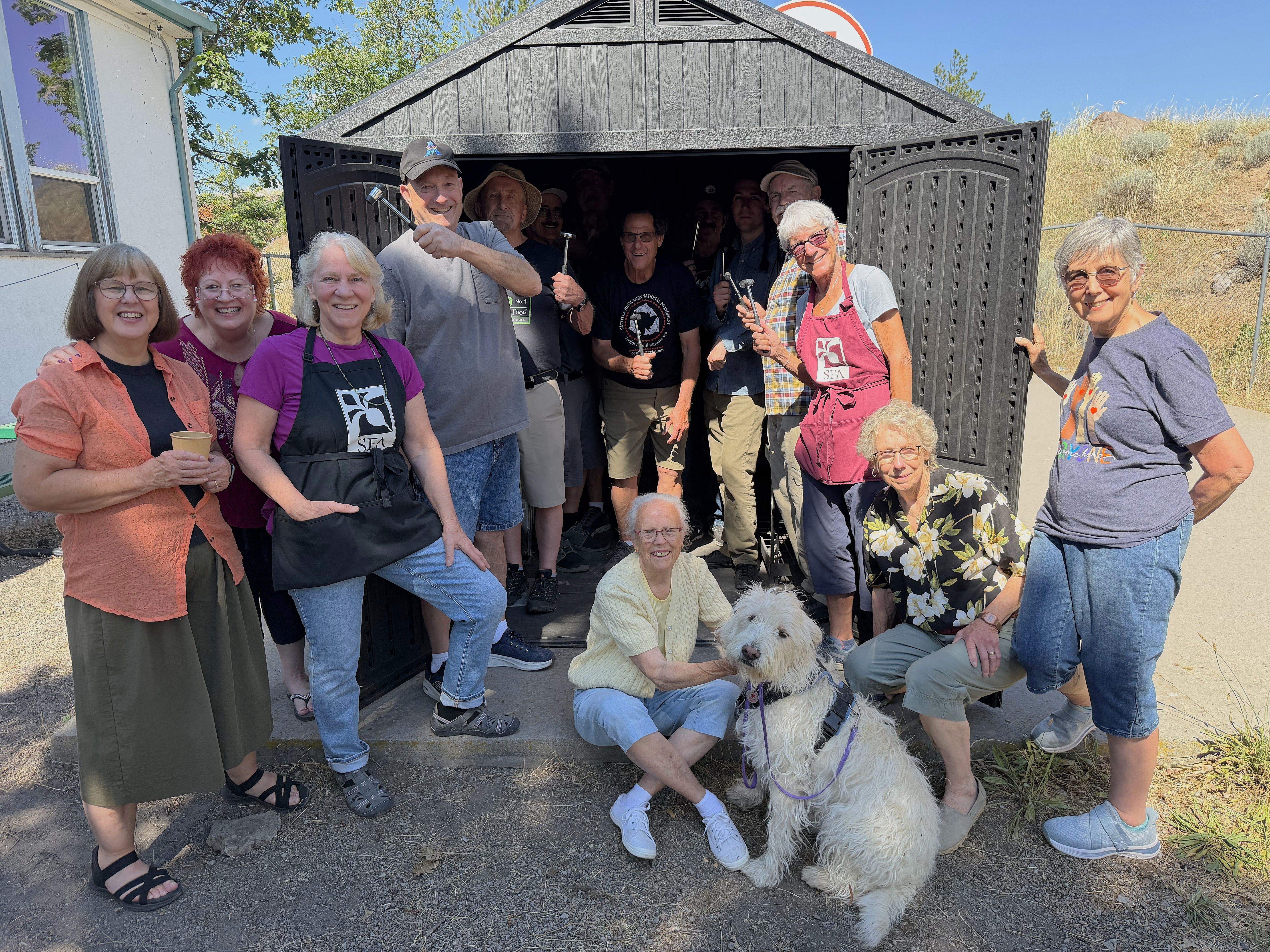 Group of volunteers with dog infront of sfa van