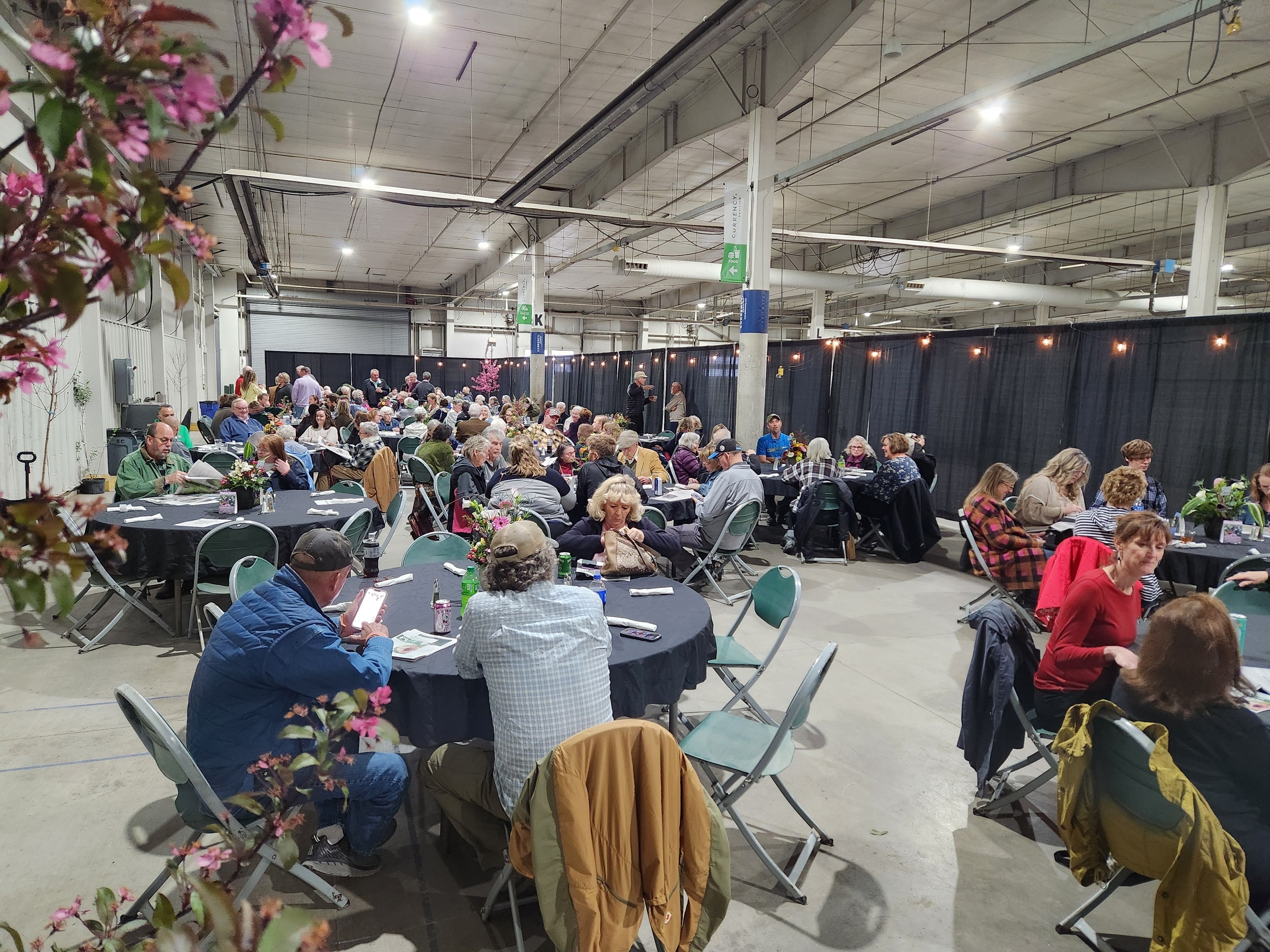 Groups of tables of people at the Spring Affair Preview Party 