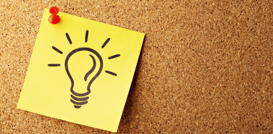 Photo of a corkboard with a sticky note on it that has the graphic of a lightbulb on it, signifying new ideas.