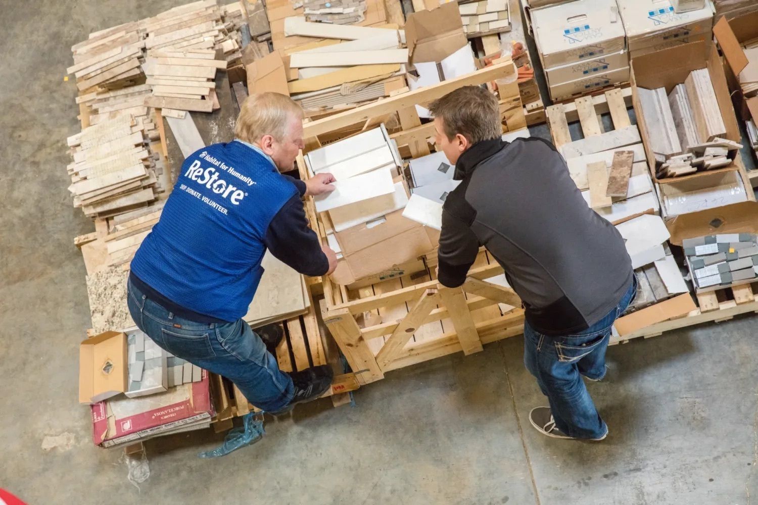 ReStore volunteer helps a customer select flooring.