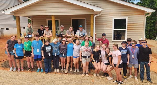 Volunteers from mFuge pose in front of 519 Habersham Lane in Easley