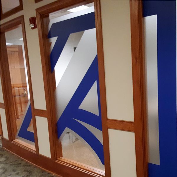 Frosted vinyl window graphics with branding installed at Augusta University's Communications Office
