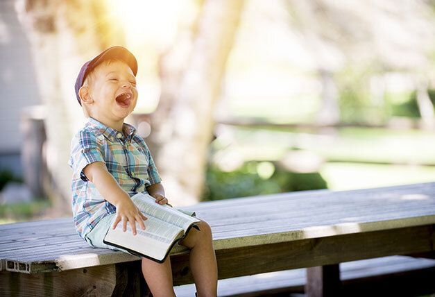 Young boy laughing.