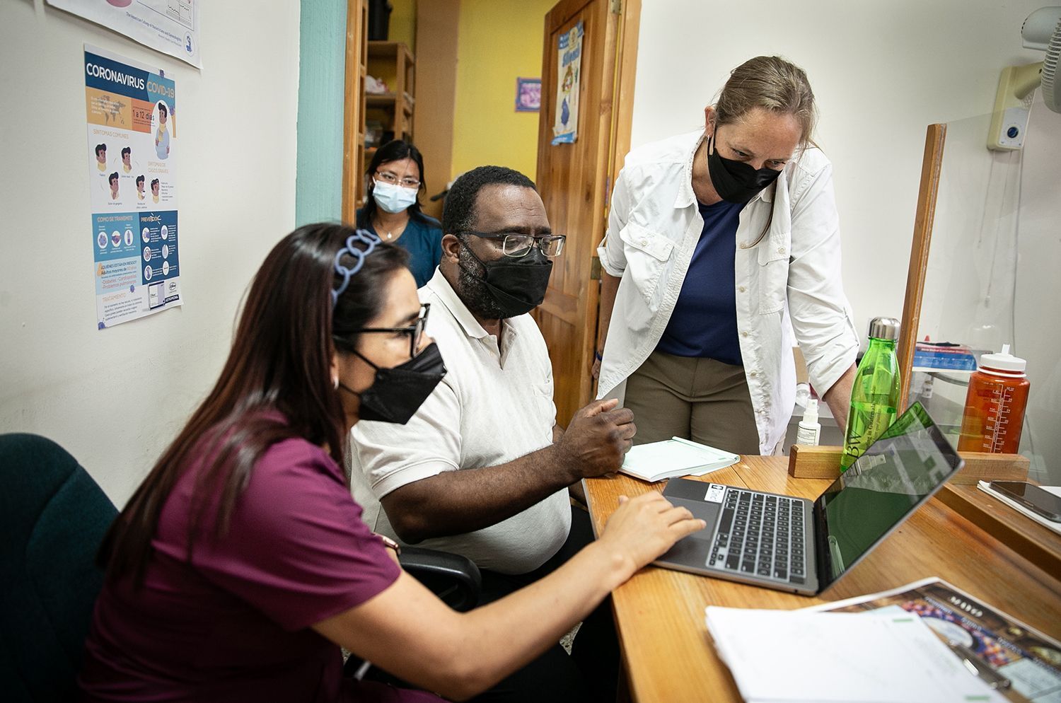 Dr. Hippler and Professor Atchinson train Dr. Lidia on the database software.