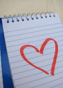 Notepad with a heart drawn on the page
