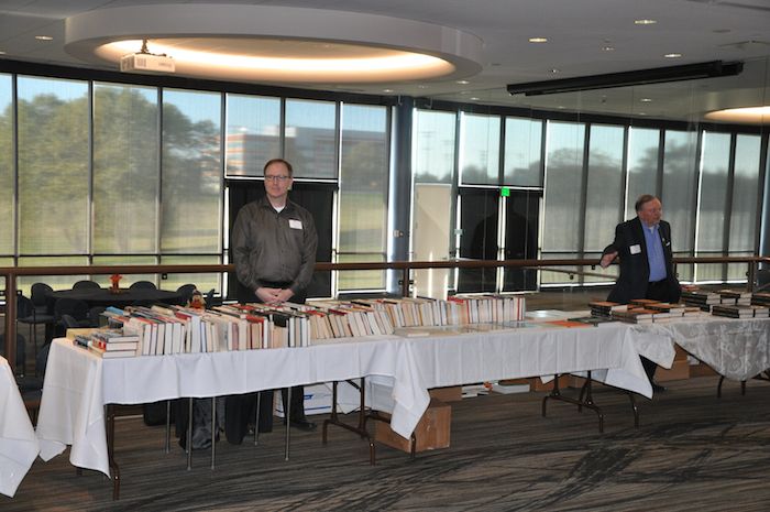 Kevin Crouse at NCMF used book sale tables and Bob Hunt at Robert Grenier and David Rohde's book signing tables. 