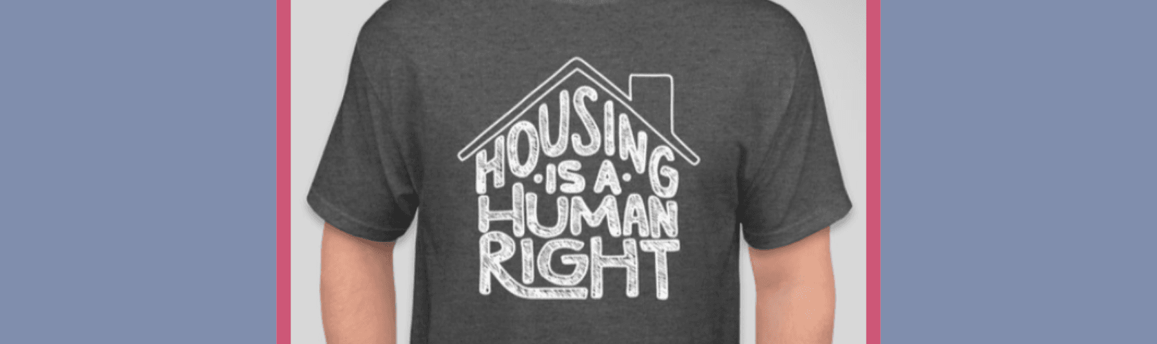 Grey t-shirt with Housing is a Human Right under an outline of a rooftop with a chimney
